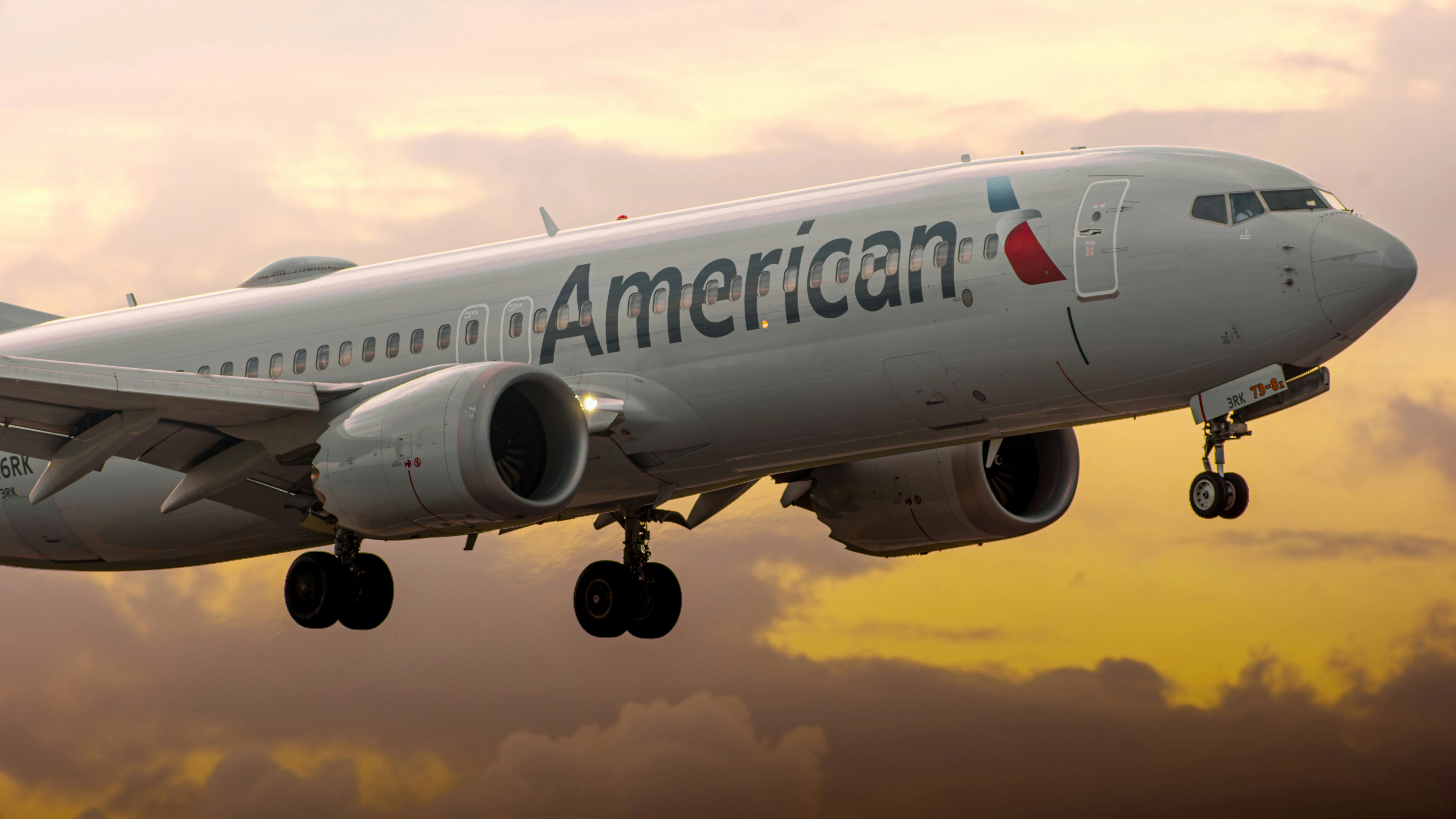 American Airlines aircraft in flight during sunset.
